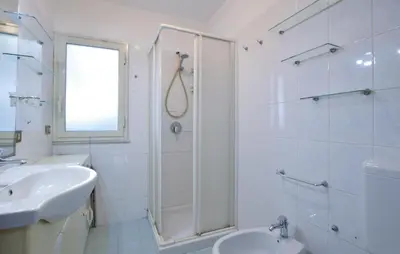 a white bathroom with a shower and a sink at Lovely Home In Altavilla Milicia in Altavilla Milicia