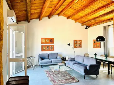 a living room with two blue couches and a table at Loft Palermo Centro con terrazzo. Free parking in Palermo