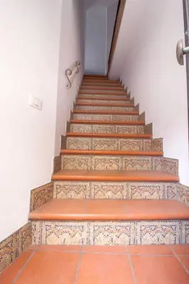 a stairway with orange tiles and a stair case at Appartamento del centro CIR 19081005C217988 in Castellammare del Golfo