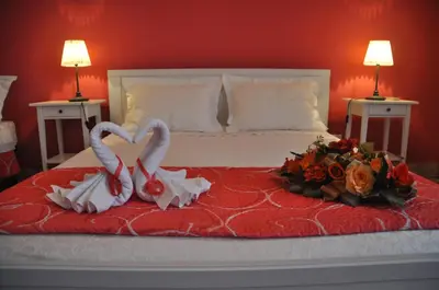 a bed with two swans making a heart at B&T Holiday House in Palermo