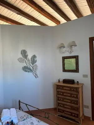 a bedroom with a bed and a dresser and a mirror at Lilla' House Center Palermo in Palermo