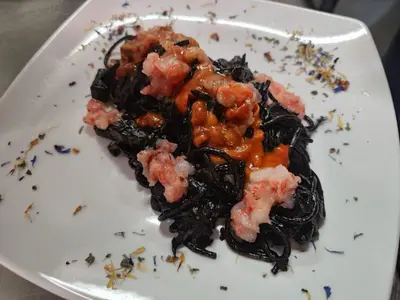 a white plate with food on top at casa giorgia mondello in Palermo