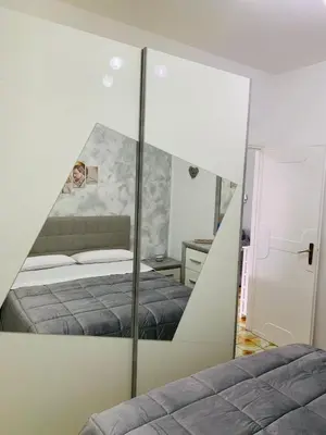 a mirror in a bedroom with a bed at casa giorgia mondello in Palermo