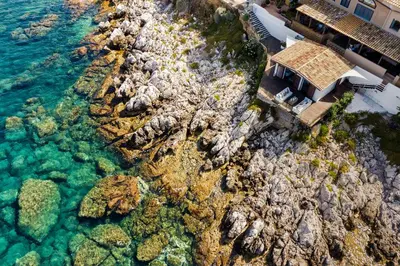 an aerial view of a house on a rocky shore at Casa del Rais con accesso privato al mare in Santa Flavia
