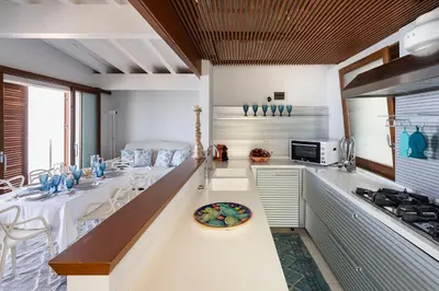a kitchen with a table with a plate on a counter at Casa del Rais con accesso privato al mare in Santa Flavia
