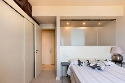 a bedroom with a bed and a table with a lamp at Casa del Rais con accesso privato al mare in Santa Flavia