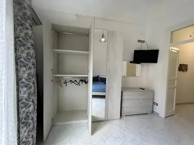 a small bedroom with a bed and a mirror at Casa Maria Rosa Deliziosa in Palermo