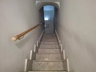 a stairway with a hand rail and a stair case at Casa Maria Rosa Deliziosa in Palermo