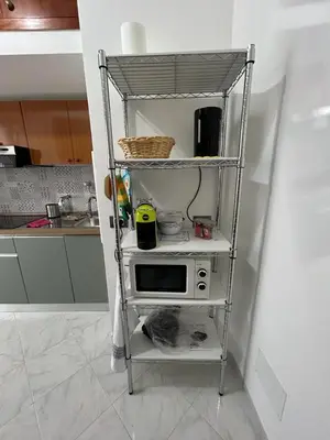 a shelf in a kitchen with a microwave on it at Casa Maria Rosa Semplice in Palermo