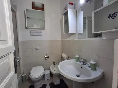 a small bathroom with a sink and a toilet at Casa Maria Rosa Semplice in Palermo