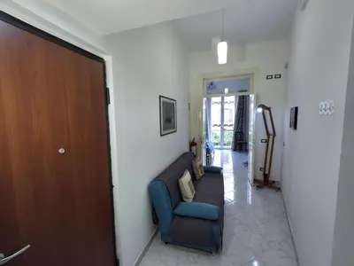 a living room with a couch and a door at Casa Maria Rosa Semplice in Palermo