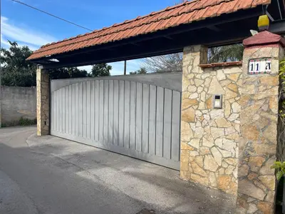 a white garage door with a stone wall at Casa Lucale in Palermo