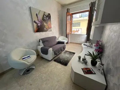 a living room with a couch and a chair and a table at Sweet Home Pietro e Lia by Holiday World in Casteldaccia