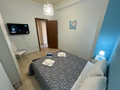 a bedroom with a bed with two towels on it at Sweet Home Pietro e Lia by Holiday World in Casteldaccia
