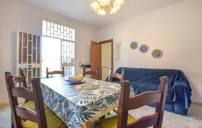 a dining room with a table with a blue table cloth at Nice Apartment In Portella Di Mare in Portella di Mare