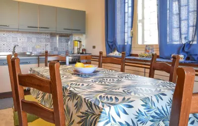 a kitchen with a table with a bowl of fruit on it at Nice Apartment In Portella Di Mare in Portella di Mare