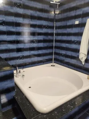 a bathroom with a white sink and a black counter at Sole nascente in Terrasini