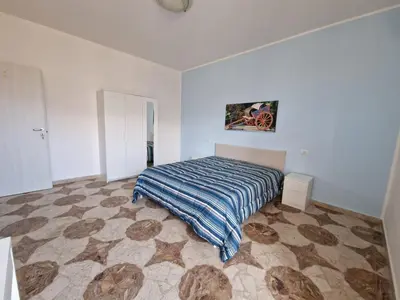 a bedroom with a bed in a white room at Sole nascente in Terrasini