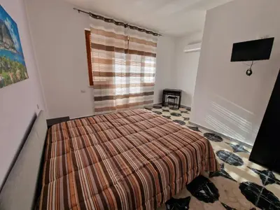 a bedroom with a bed and a television in it at Sole nascente in Terrasini