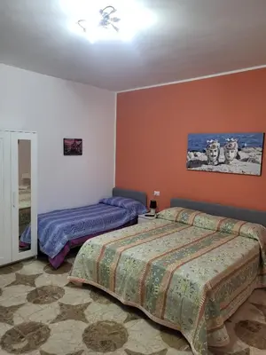a bedroom with two beds and a ceiling fan at Sole nascente in Terrasini