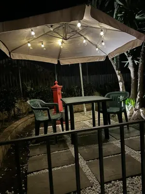 a table and two chairs under an umbrella at L'abete in Villabate