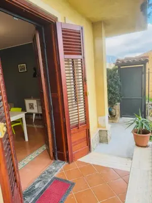 an open door to a house with a patio at L'abete in Villabate