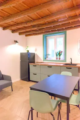 a kitchen with a table and chairs in a room at Le Dame di Sicilia Sicilian Vintage Rooms in Palermo