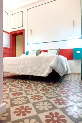 a bedroom with a large bed in a room at Le Dame di Sicilia Sicilian Vintage Rooms in Palermo