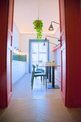 a kitchen with a table and chairs in a room at Le Dame di Sicilia Sicilian Vintage Rooms in Palermo