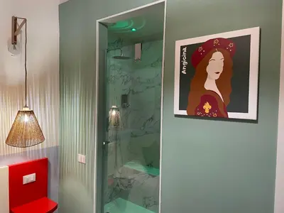 a painting of a woman is on the wall of a bathroom at Le Dame di Sicilia Sicilian Vintage Rooms in Palermo