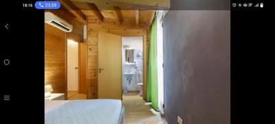 a room with a bed and a hallway with a bathroom at Palermo sweet house in Palermo
