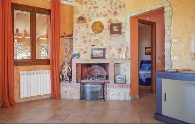 a living room with a stone fireplace in a house at Doppia villa indipendente/clara in Mandra Capreria