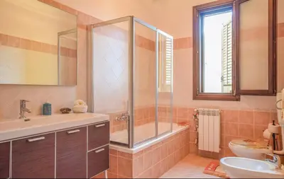 a bathroom with a shower and a sink and a toilet at Doppia villa indipendente/clara in Mandra Capreria