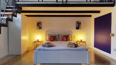 a bedroom with a large bed in a room at Cappuccini 145 R&P -Parcheggio gratis-Centro Storico-Cattedrale in Palermo