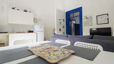 a living room with a couch and a table at Cappuccini 145 R&P -Parcheggio gratis-Centro Storico-Cattedrale in Palermo