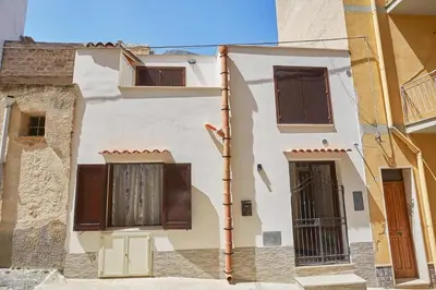 a white building with brown shutters on it at CASA FATIMA in Castellammare del Golfo