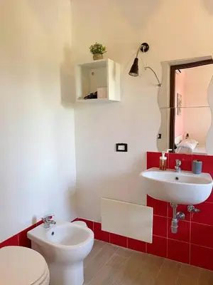 a bathroom with a white toilet and a sink at B&B Pelagos in Castellammare del Golfo