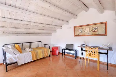 a bedroom with a bed and a desk and a computer at Casa Querencia rooms in Palermo