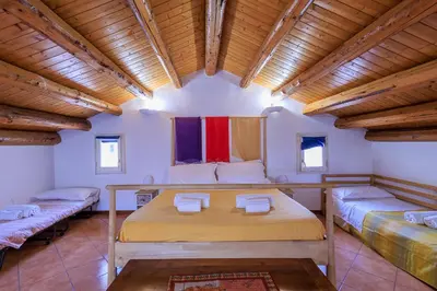 a room with two beds in a room with wooden ceilings at Casa Querencia rooms in Palermo