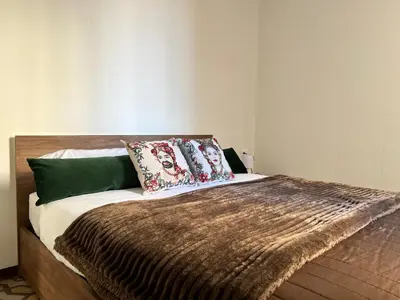 a bed with two pillows on top of it at M'AMA apartment in Ficarazzi