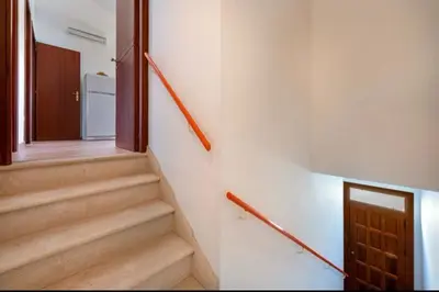 a hallway with stairs and a door in a building at Marconi in San Vito lo Capo