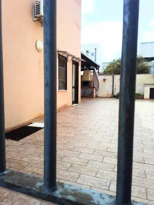 a building with two poles in front of it at Marconi in San Vito lo Capo