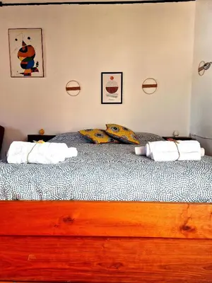 a bed with two pillows on it in a bedroom at Wood House - Palermo in Palermo