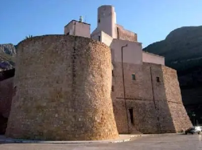 a large building with a tower on top of it at Ancilinas House in Castellammare del Golfo