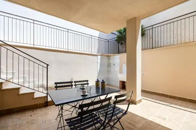 a dining room with a table and chairs at La Dimora del Mare by Domus Sicily in Mondello