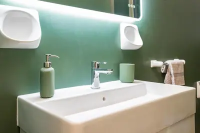 a bathroom with a sink and a green wall at Bibi house a San Giovanni degli Eremiti in Palermo