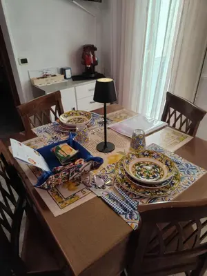 a table with plates and a lamp on top of it at Casa Swamy in Palermo