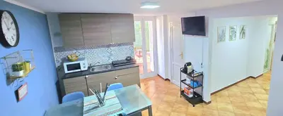 a kitchen with a table and a microwave at Montesanto Home in Palermo