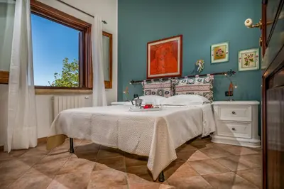 a bedroom with a bed with a sink and a window at Villa Miceli in Scopello