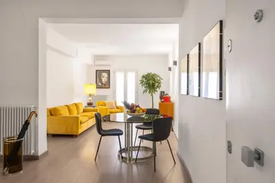 a living room with a table and a yellow couch at 70 Lab Apartment in Palermo